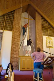 Die Kirche wird für den Ostergottesdienst am Oster Sonntag geschmückt. Weiß ersetzt Lila.